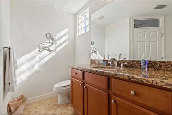 a bathroom with a granite countertop sink a mirror and a bathtub