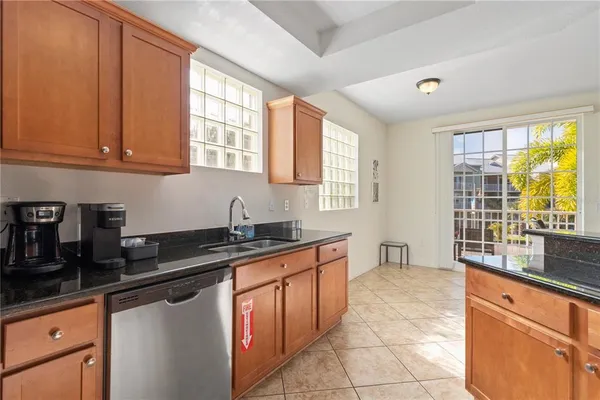 a kitchen with stainless steel appliances granite countertop a stove top oven a sink a counter space and cabinets