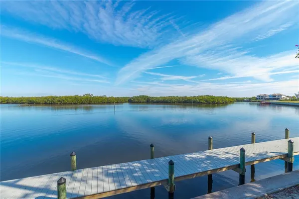 an outdoor space with patio lots of furniture and lake view