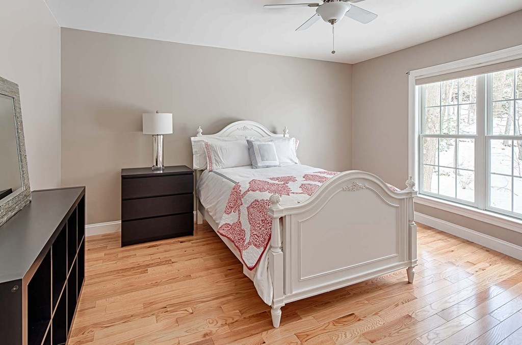 3 Ballard Terrace Lexington, MA 02420 - Photo 17 of 24 a bed room with a bed and a chandelier