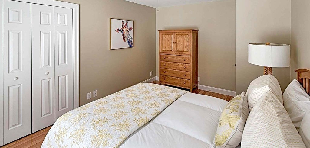 3 Ballard Terrace Lexington, MA 02420 - Photo 18 of 24 a bedroom with a bed and a lamp on dresser