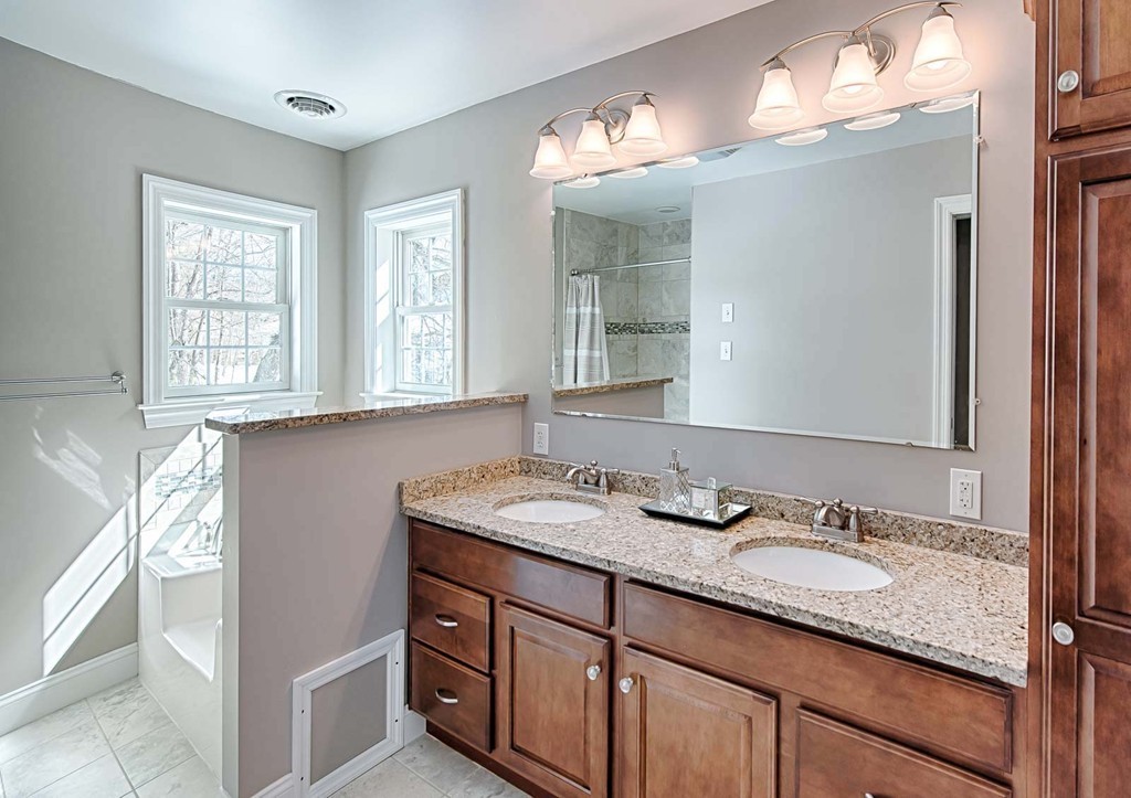 3 Ballard Terrace Lexington, MA 02420 - Photo 21 of 24 a bathroom with a granite countertop sink and a mirror
