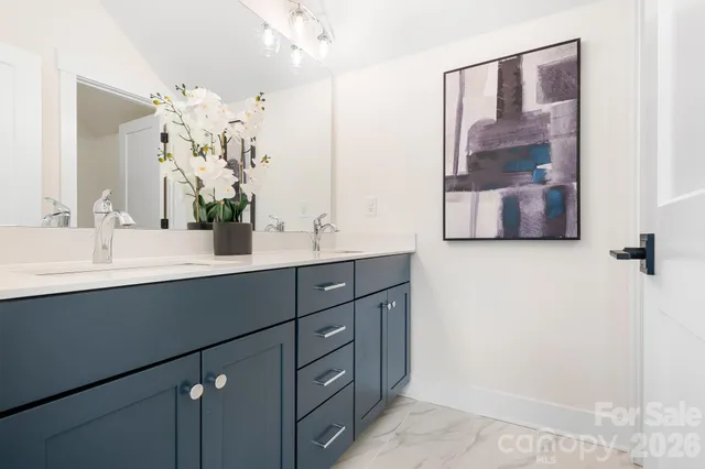 a living room with furniture a large window and a fireplace