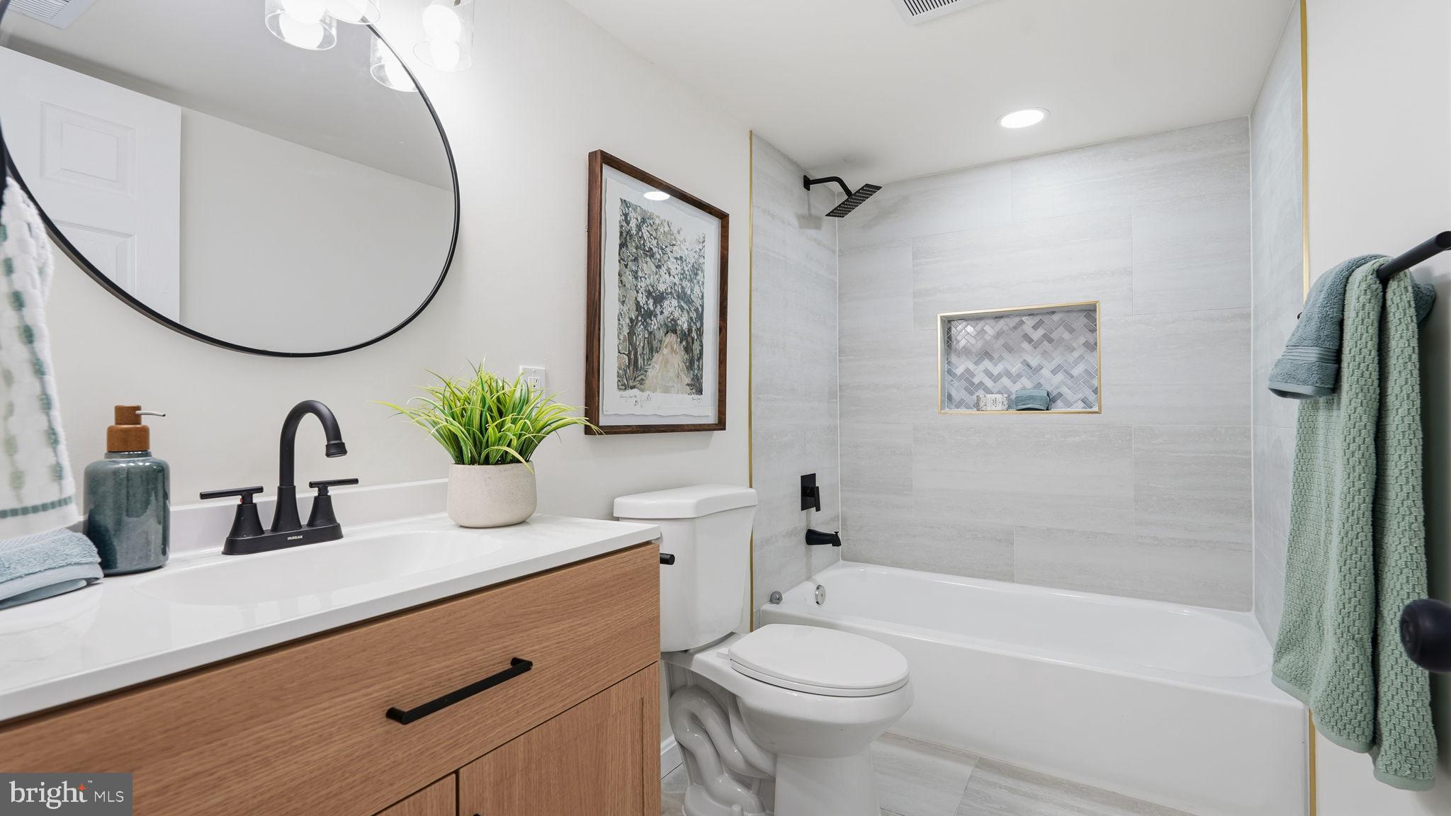 12219 River Road Remington, VA 22734 - Photo 19 of 31 a bathroom with a sink a mirror a toilet and a bathtub
