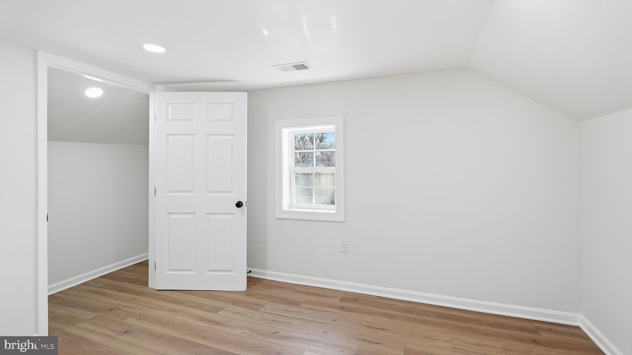 12219 River Road Remington, VA 22734 - Photo 22 of 31 a view of an empty room with wooden floor and a window