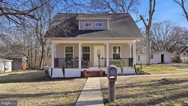 a view of a brick house with a large tree