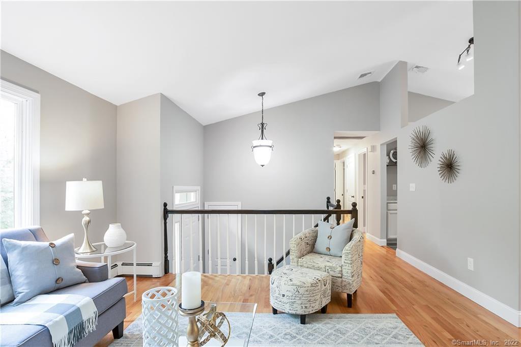 132 South Hoop Pole Road Guilford, CT 06437 - Photo 1 of 1 a bedroom with furniture and wooden floor