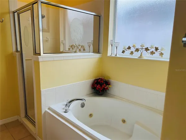 a bathroom with a tub and shower