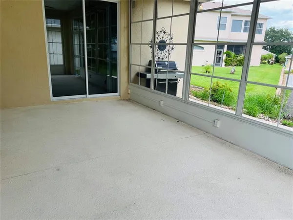 a view of a porch with a floor to ceiling window and yard