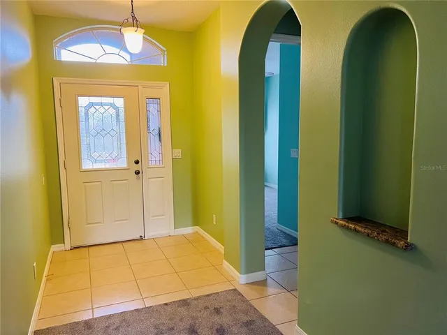 a view of an entryway with a chandelier