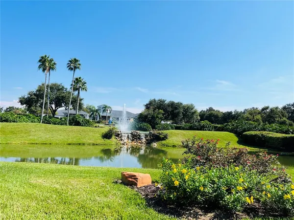 a view of a golf course with a lake view