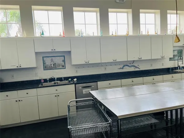 a kitchen with a sink cabinets and window