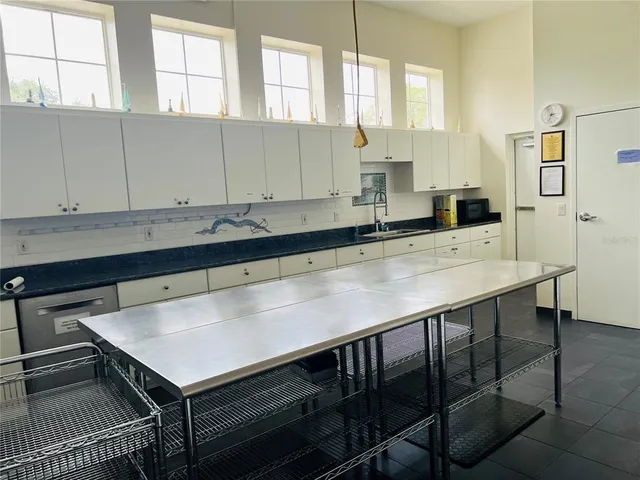 a kitchen with a sink cabinets and window