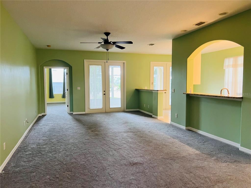 5446 Sea Leopard Street Tavares, FL 32778 - Photo 3 of 39 a view of a hallway with a chandelier