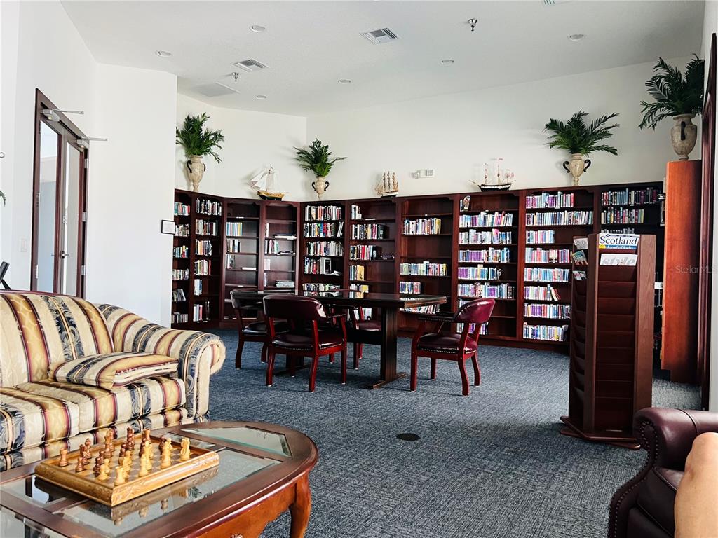 5446 Sea Leopard Street Tavares, FL 32778 - Photo 33 of 39 a living room with furniture a couch and potted plant