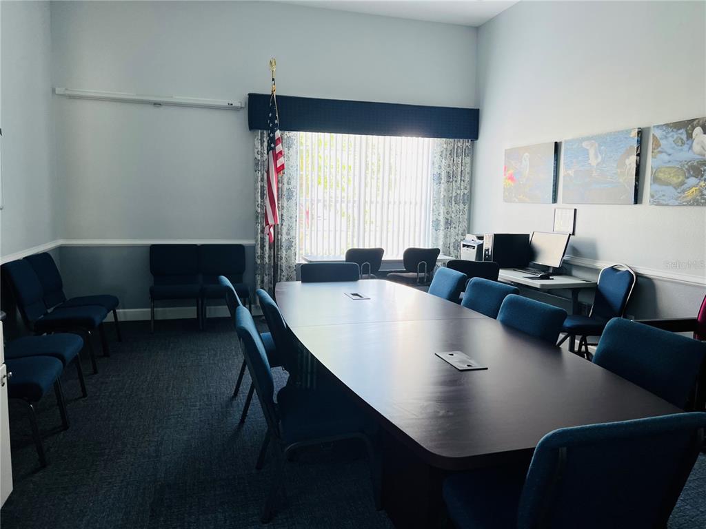 5446 Sea Leopard Street Tavares, FL 32778 - Photo 34 of 39 a living room with furniture and a large window