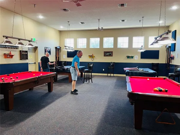 a living room with kitchen furniture pool and a table