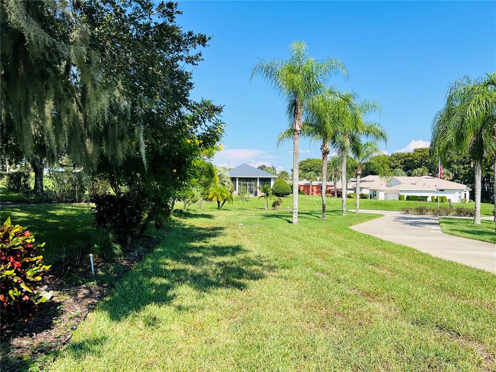 5446 Sea Leopard Street Tavares, FL 32778 - Photo 37 of 39 a view of green field with sitting area