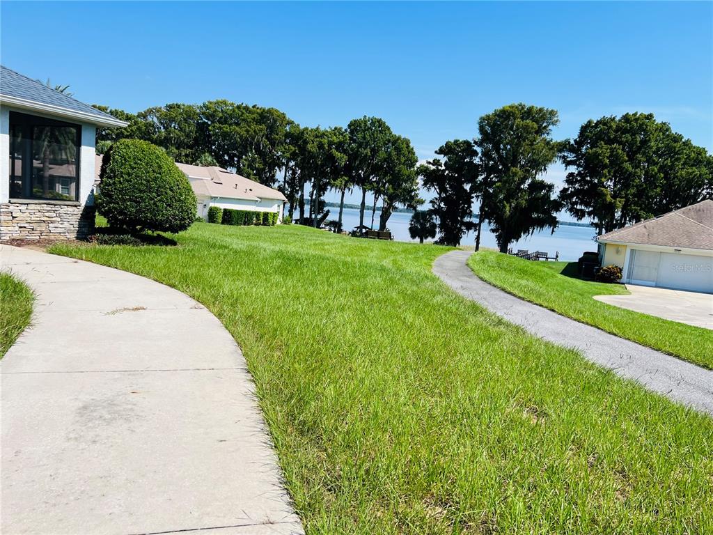 5446 Sea Leopard Street Tavares, FL 32778 - Photo 38 of 39 a view of a garden with houses