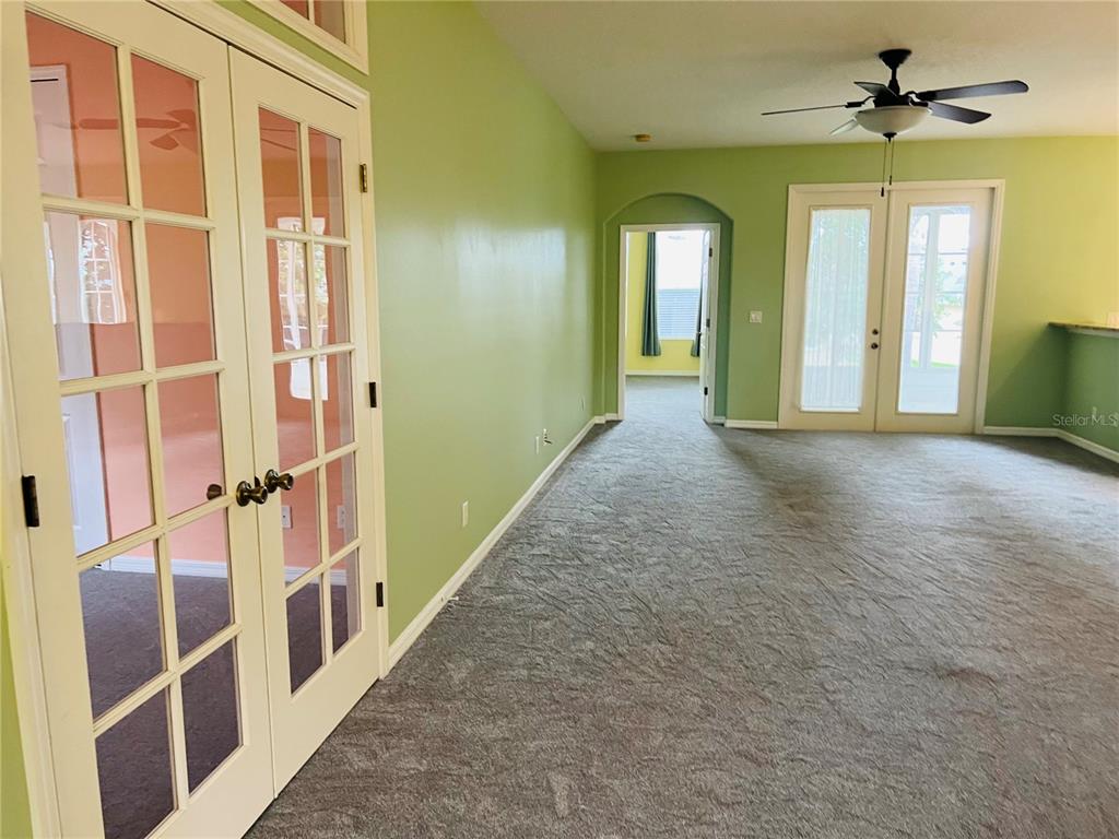 5446 Sea Leopard Street Tavares, FL 32778 - Photo 6 of 39 a view of a hallway with wooden floor and windows