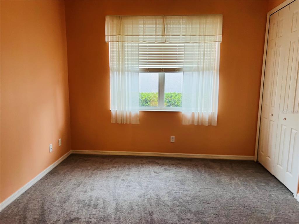 5446 Sea Leopard Street Tavares, FL 32778 - Photo 7 of 39 an empty room with a window