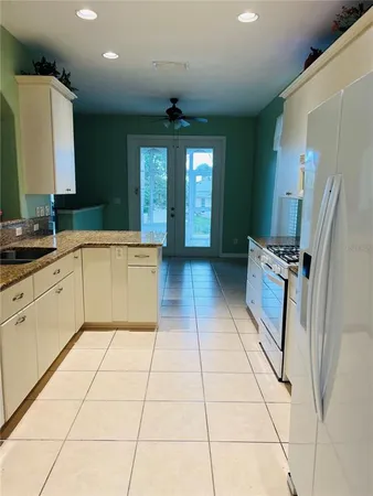 a kitchen with stainless steel appliances granite countertop a refrigerator and a sink
