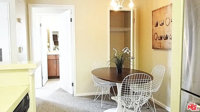 a dining room with table and chairs