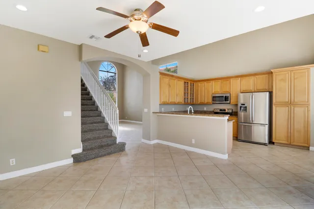 a view of kitchen with stainless steel appliances a refrigerator and a stove top oven