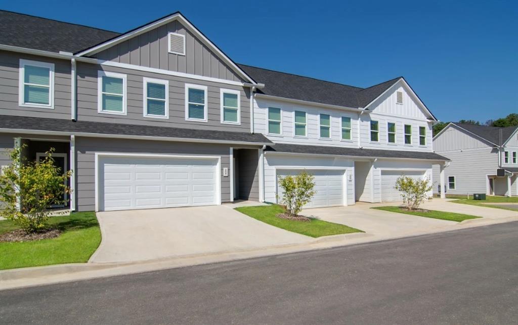 5055 Southwood Road, Unit 2103 Union City, GA 30213 - Photo 18 of 24 a front view of a house with a yard and garage