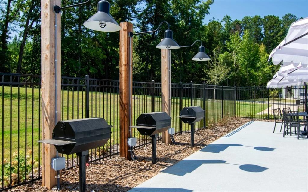 5055 Southwood Road, Unit 2103 Union City, GA 30213 - Photo 22 of 24 a view of a chair and tables in the backyard