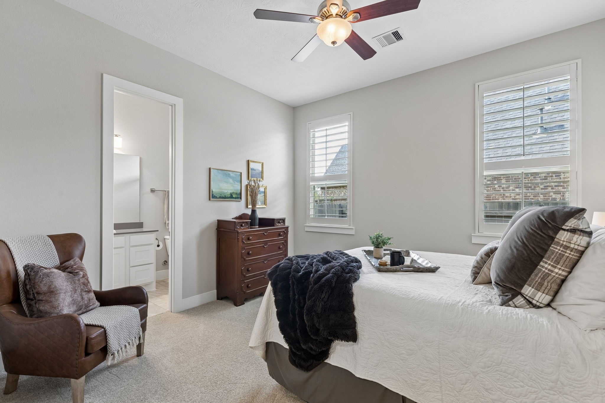 6514 Woodleaf Lake Loop Katy, TX 77493 - Photo 17 of 32 This spacious secondary bedroom is one of two en-suite guest rooms, offering a private full bath. High ceilings and ceiling fans throughout ensure a comfortable environment for guests or family.