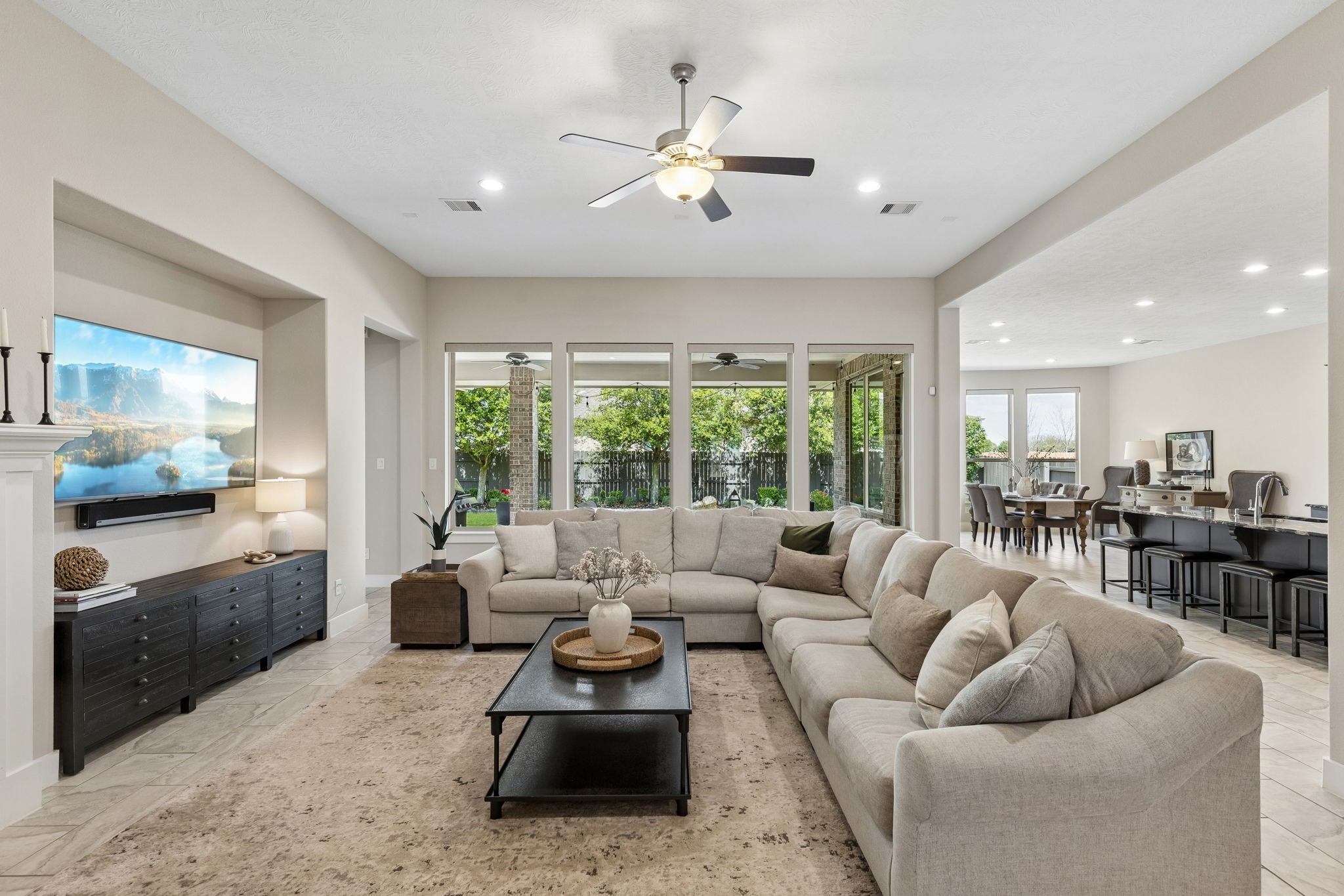 6514 Woodleaf Lake Loop Katy, TX 77493 - Photo 2 of 32 This wide-angle perspective showcases the seamless flow between the family room and the kitchen, perfect for grand-scale entertaining.