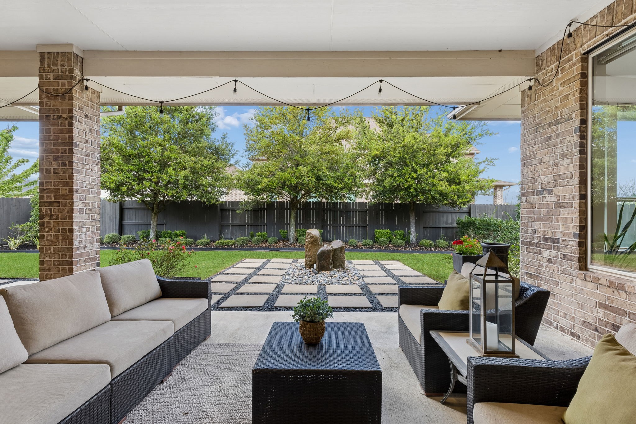 6514 Woodleaf Lake Loop Katy, TX 77493 - Photo 23 of 32 The covered patio offers plenty of space for a lounge setup or outdoor dining, creating a versatile area to enjoy the backyard. There is a natural gas line available for your grill!