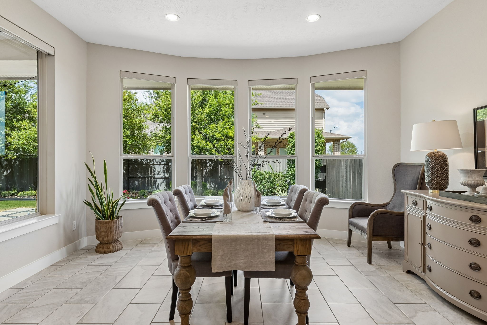 6514 Woodleaf Lake Loop Katy, TX 77493 - Photo 9 of 32 Enjoy formal meals in this intimate dining space framed by a wall of high-efficiency, low-E windows. The space features designer tile flooring and updated light fixtures for a modern, refined atmosphere.