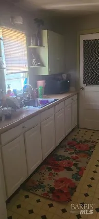 a kitchen with sink and window