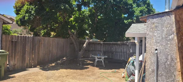 a view of a backyard with a small cabin and a chair