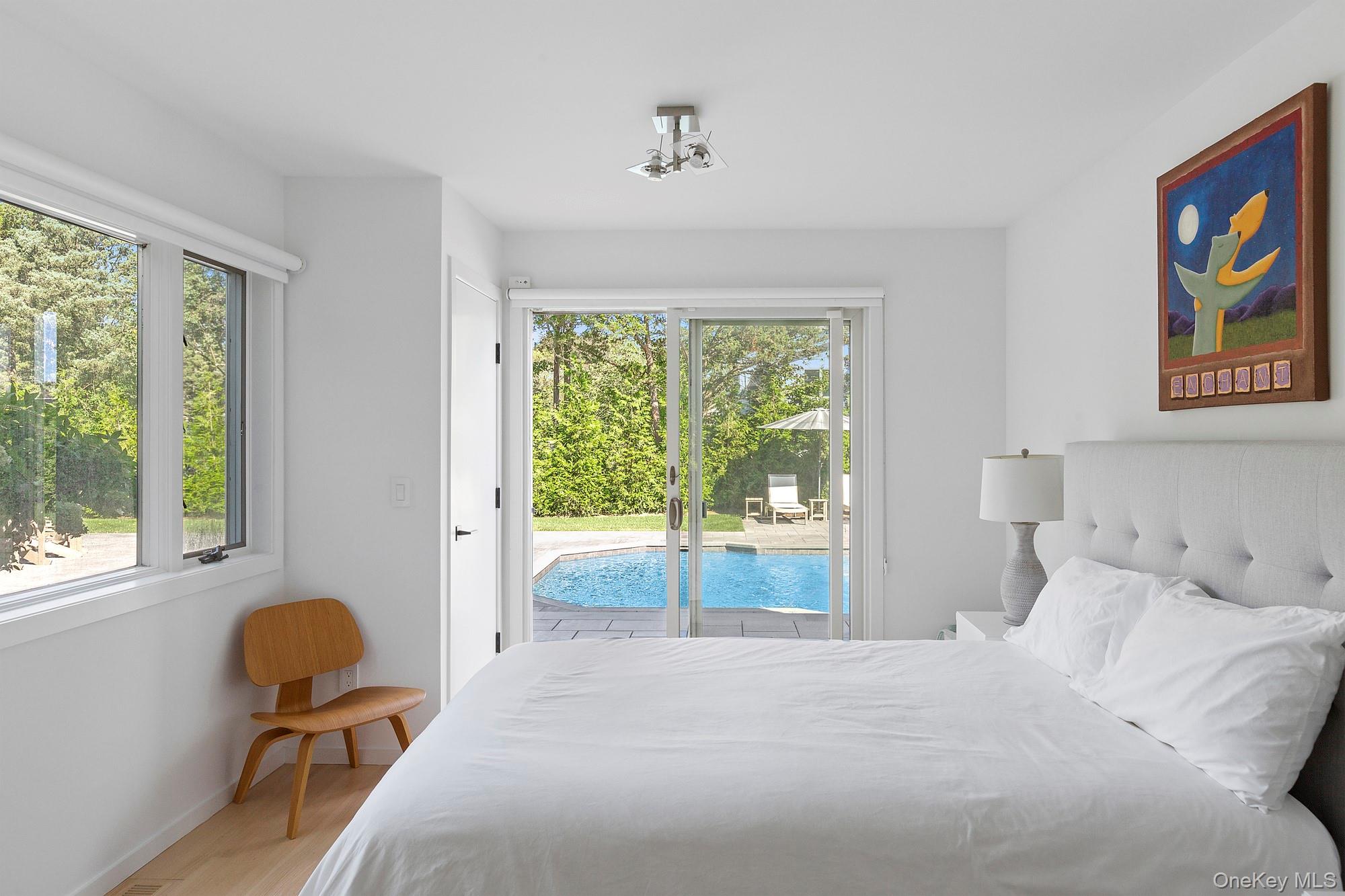 4 Bayberry Lane Remsenburg, NY 11960 - Photo 14 of 27 a bedroom with a bed and wooden floor