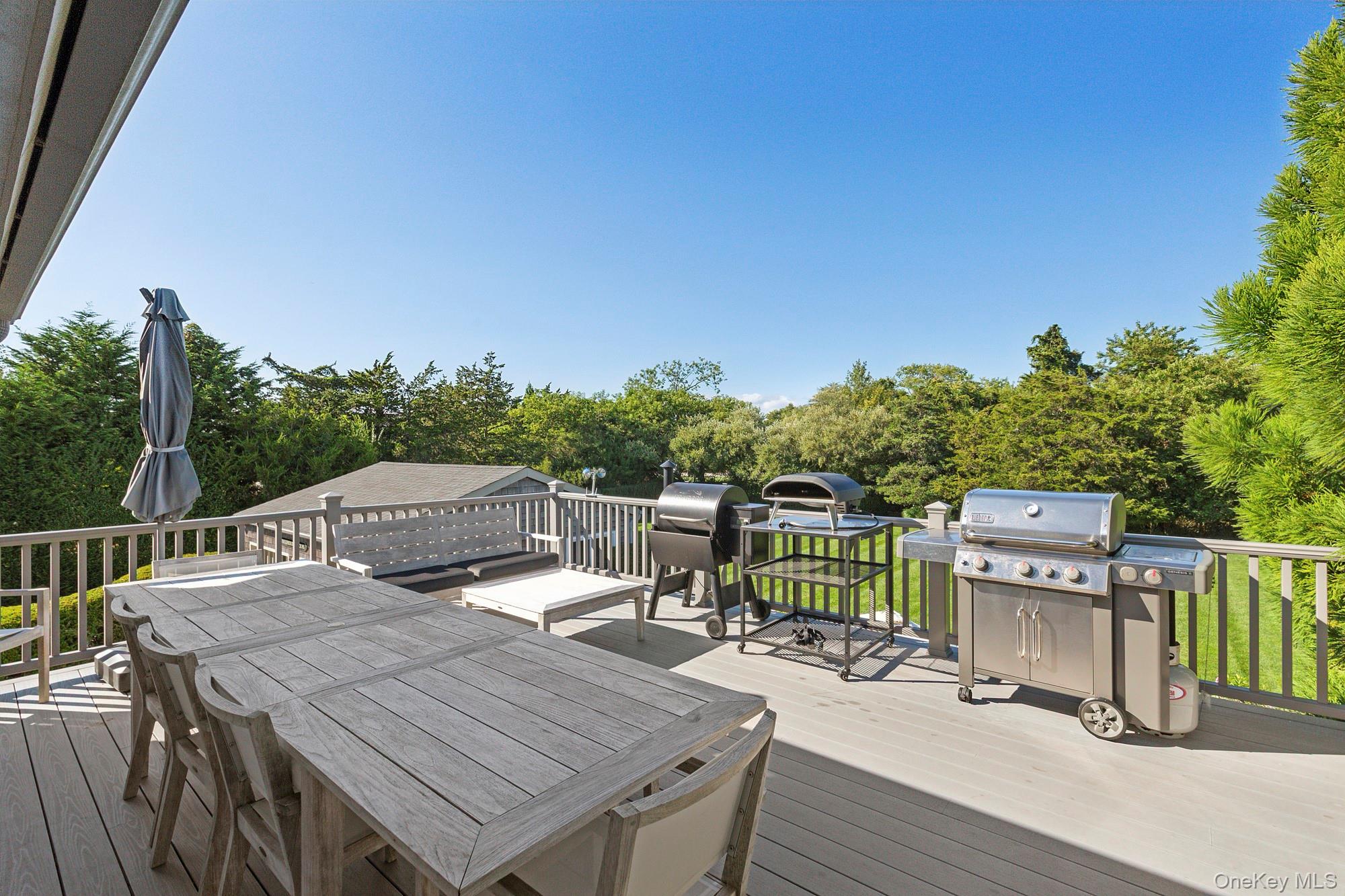 4 Bayberry Lane Remsenburg, NY 11960 - Photo 18 of 27 a view of a deck with furniture and trees