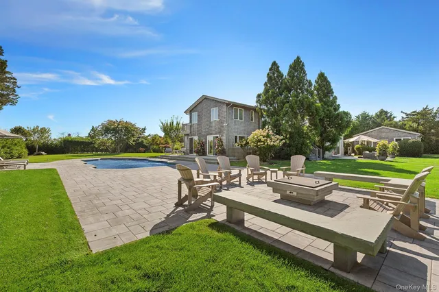 a view of a house with a yard and a patio