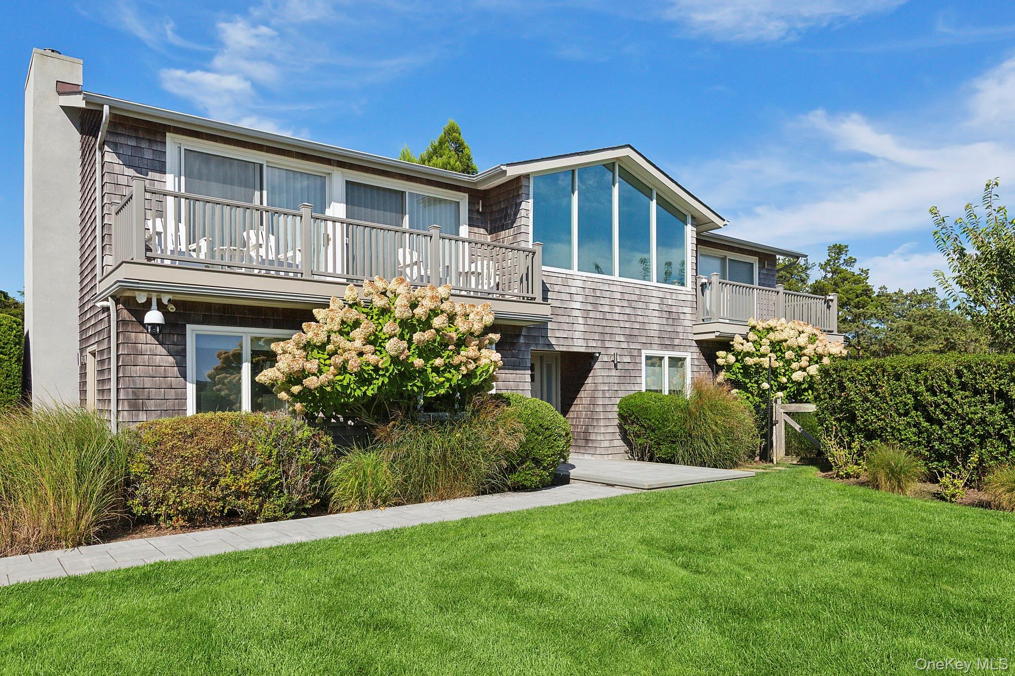 4 Bayberry Lane Remsenburg, NY 11960 - Photo 3 of 27 a front view of a house with a garden