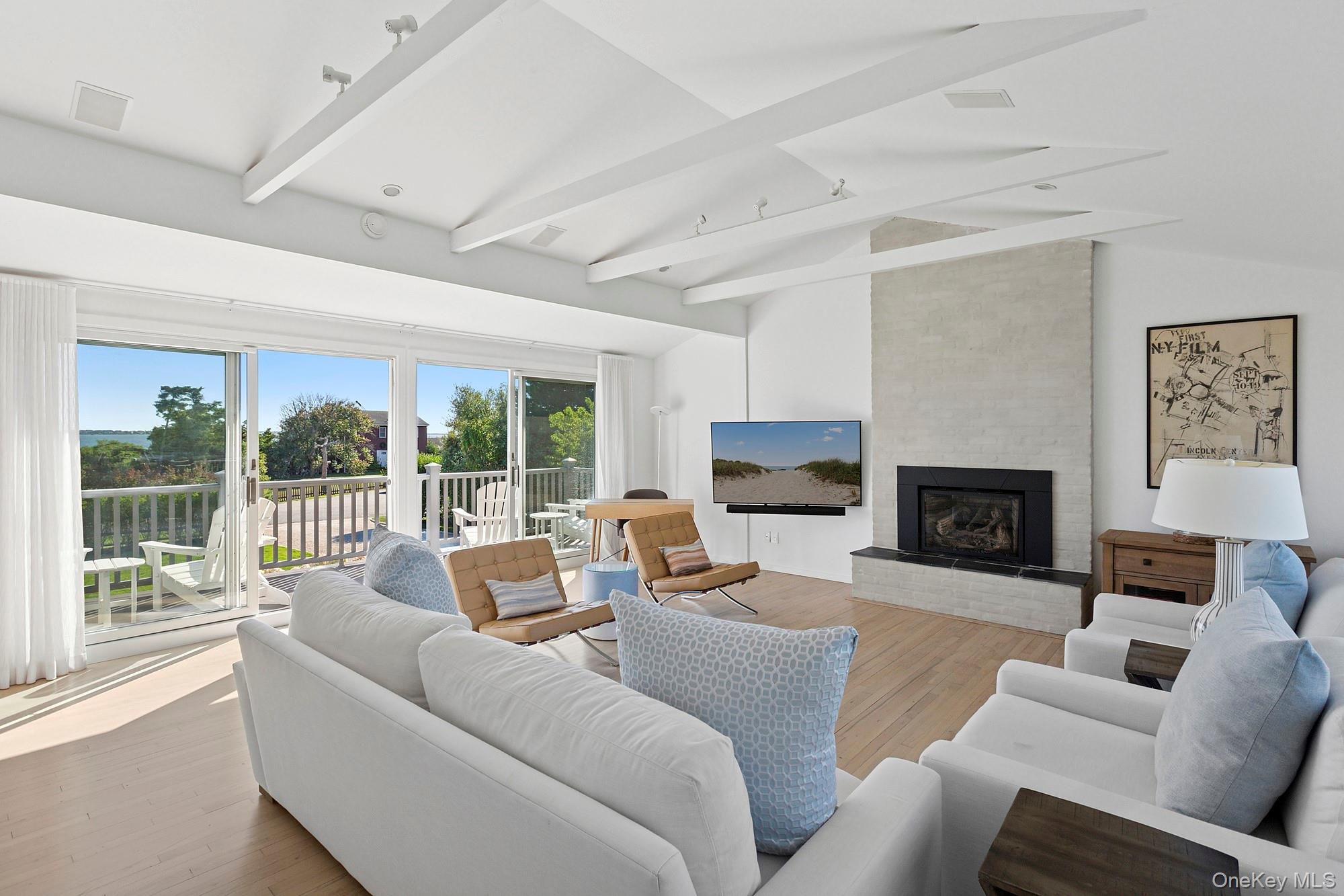 4 Bayberry Lane Remsenburg, NY 11960 - Photo 4 of 27 a living room with furniture and a fireplace
