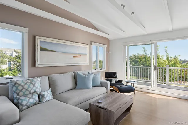 a living room with furniture and large windows