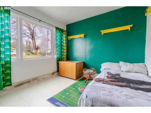 a bedroom with furniture and a window