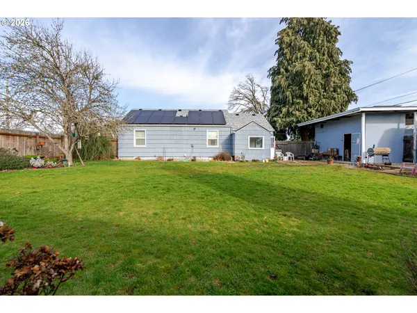 a house view with a sitting space and garden