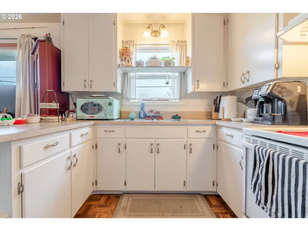 a kitchen with a sink window and cabinets