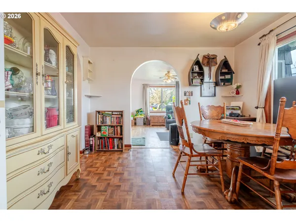 a view of a dining room with furniture and a large window