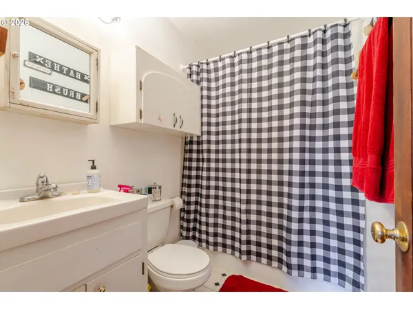 a bathroom with a sink a toilet and a mirror