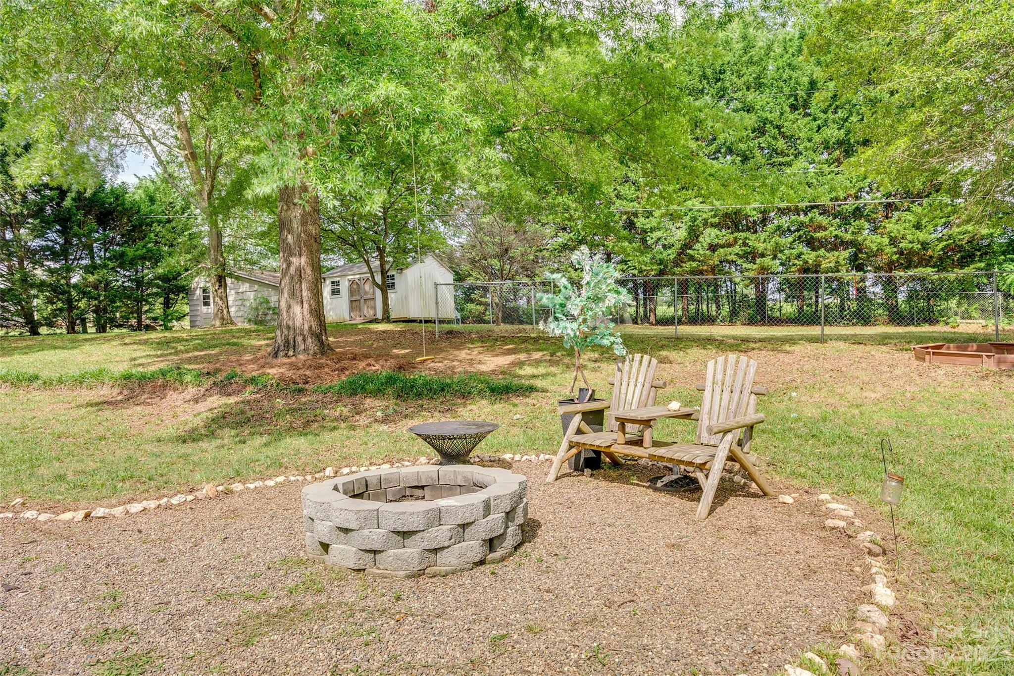 377 Rainbow Circle Clover, SC 29710 - Photo 24 of 29 a view of a lake with a table and chairs in patio