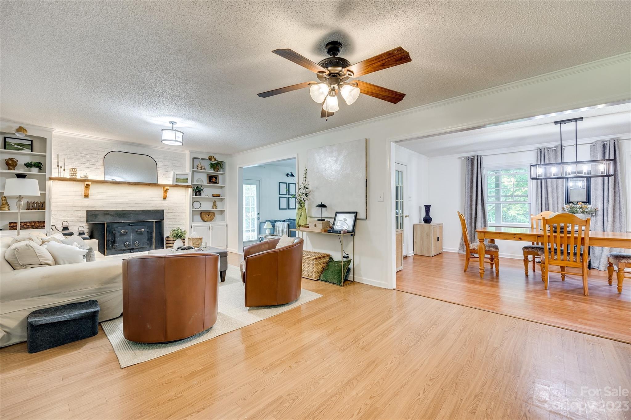 377 Rainbow Circle Clover, SC 29710 - Photo 8 of 29 a living room with furniture a fireplace and a chandelier