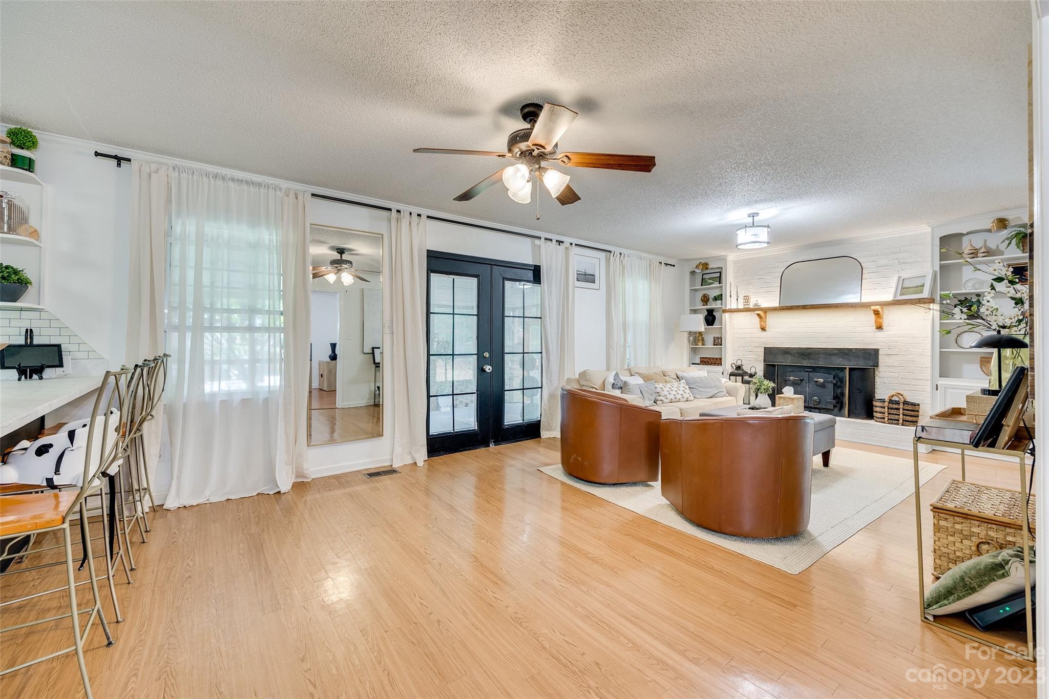 377 Rainbow Circle Clover, SC 29710 - Photo 9 of 29 a living room with furniture a fireplace and a chandelier
